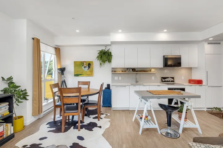 Kitchen with white cabinetry, light countertops, backsplash, light wood-style flooring, and recessed lighting