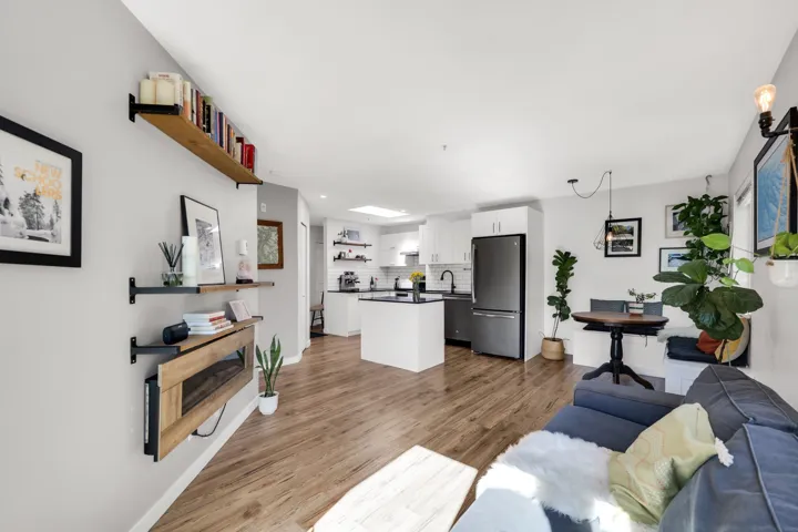 Open-concept living space featuring wood-finish flooring and a neutral color palette