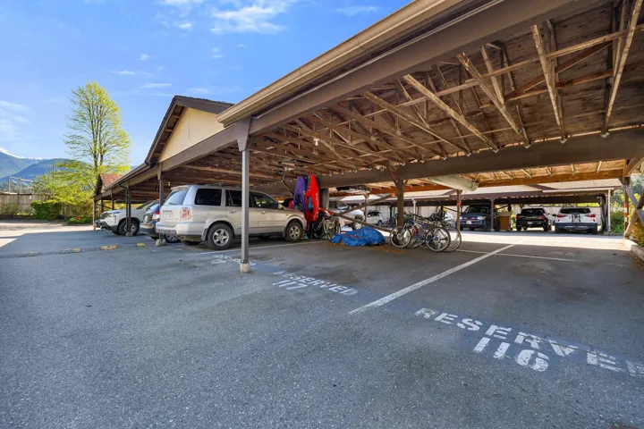 Covered parking structure with individual reserved spaces and a paved lot