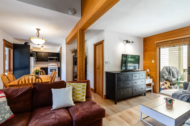 Living area featuring light wood-type flooring and wooden walls