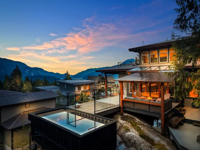 Modern exterior architecture featuring multiple levels, expansive deck spaces, an elevated plunge pool, and a covered outdoor lounge area with a built-in fire feature
