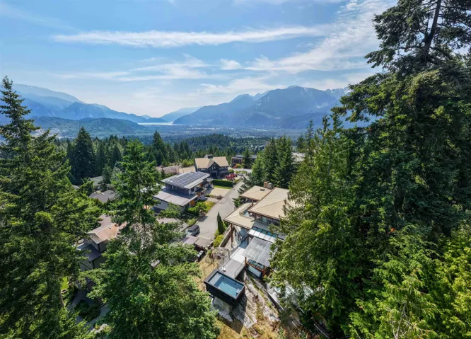 Elevated property featuring a private plunge pool, expansive surrounding forested areas, and panoramic mountain and water scenery