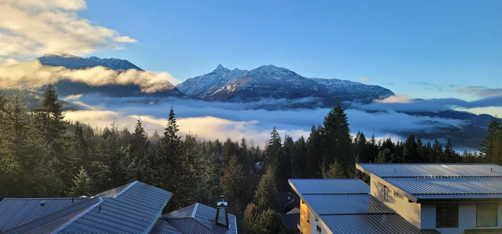 Mountain backdrop with snow-capped peaks and cloud inversions