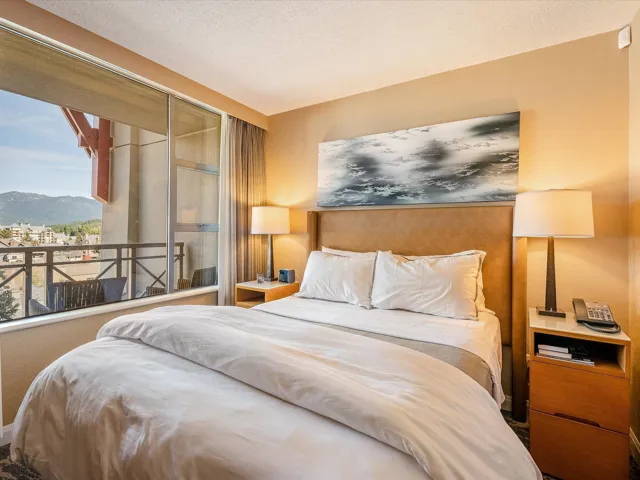 Kitchen featuring baseboards, decorative backsplash, appliances with stainless steel finishes, light brown cabinetry, and a sink