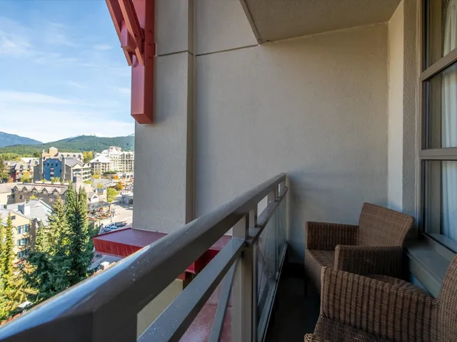 Living room with carpet, crown molding, a textured ceiling, and baseboards