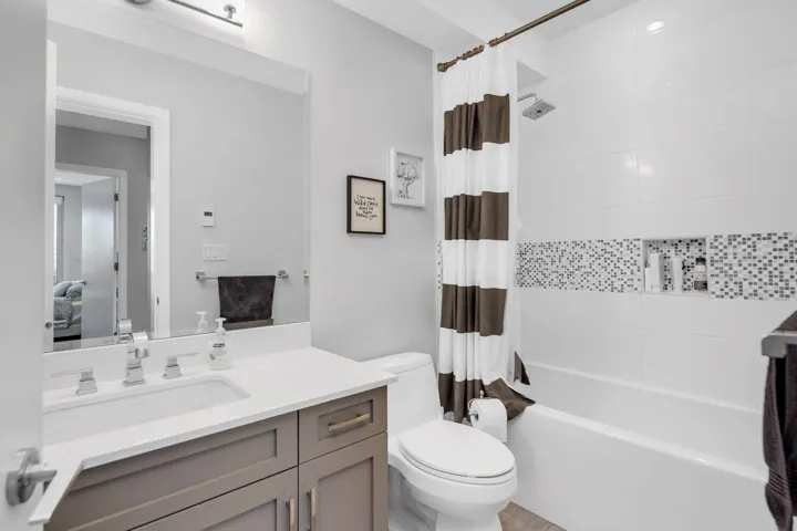 Bathroom featuring vanity and shower / tub combo