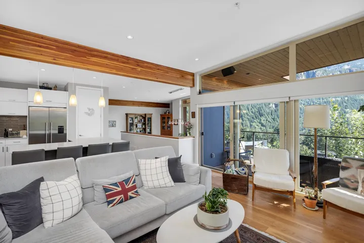 Living area with recessed lighting, wood finished floors, and beamed ceiling