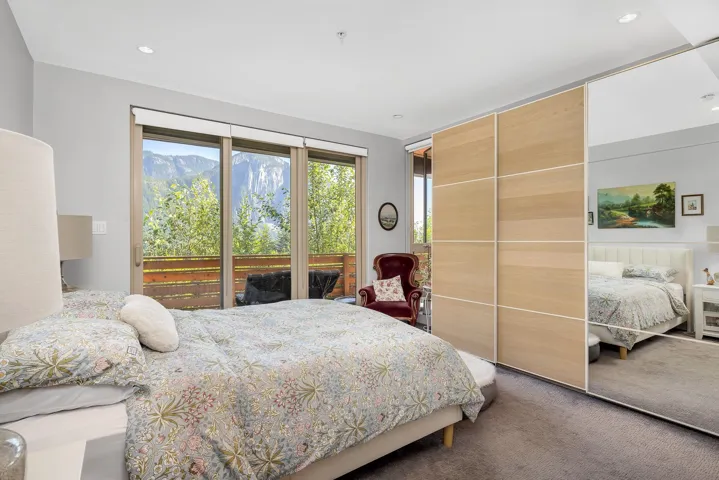 Bedroom with carpet, recessed lighting, access to outside, and a mountain view