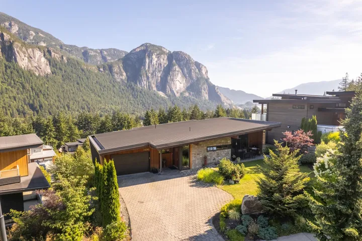View of front of house with a garage, a mountain view, and decorative driveway