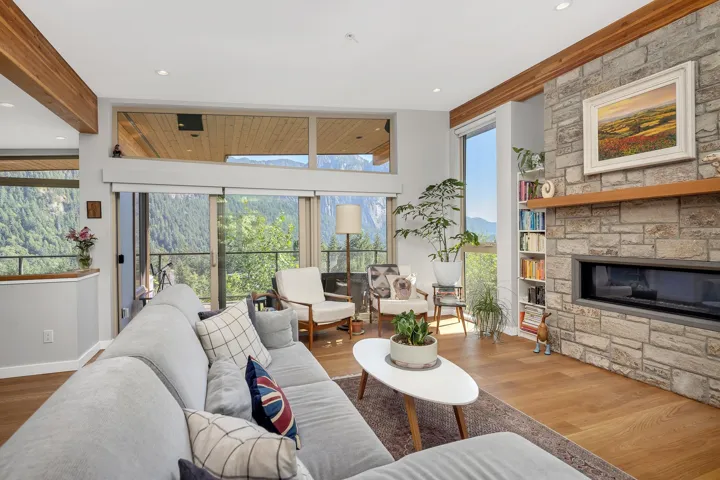 Living area featuring wood finished floors, plenty of natural light, a fireplace, and recessed lighting