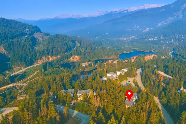Aerial view of property and surrounding area with a water and mountain view