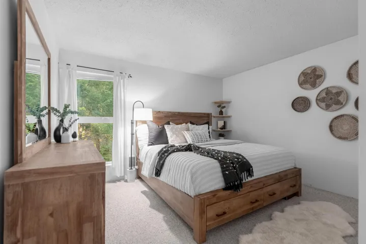 Bedroom featuring a textured ceiling and carpet