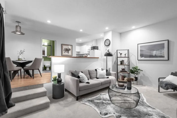 Living room with recessed lighting and light carpet