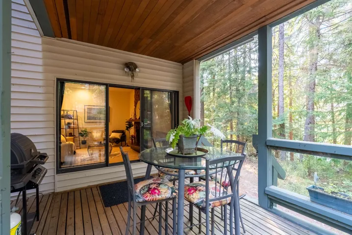 Sunroom with a wooden deck, plenty of natural light, and outdoor dining area
