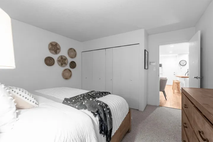 Bedroom featuring light colored carpet and a closet