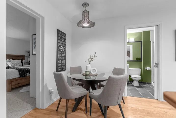 Dining area with light wood-style floors and baseboards