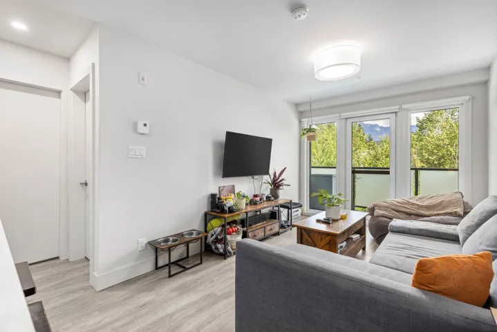 Living room featuring light wood-type flooring and baseboards