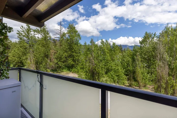 Balcony featuring a forest view