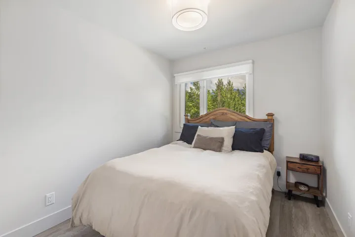 Bedroom with wood finished floors and baseboards