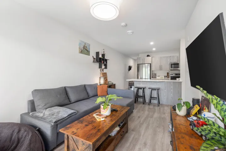 Living room featuring light wood finished floors and recessed lighting