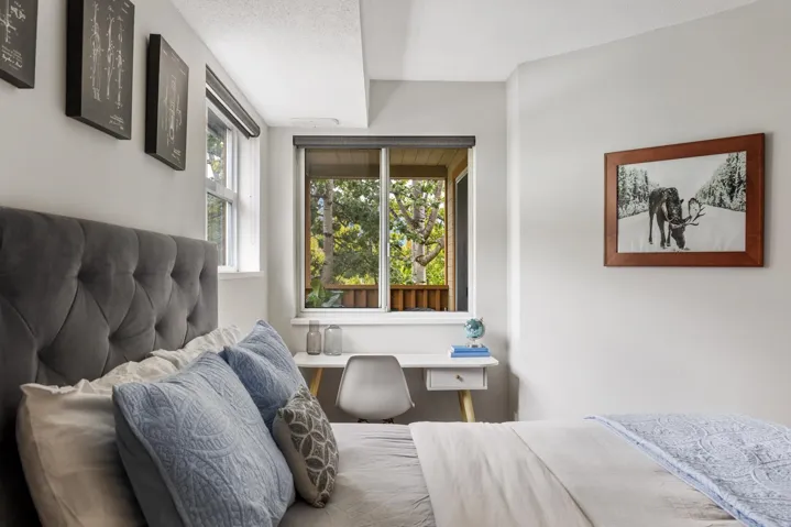Bedroom with built in study area and a textured ceiling
