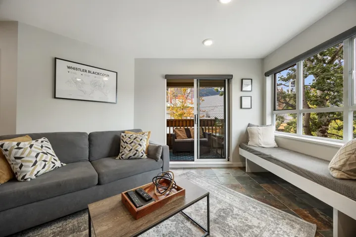 Living room with stone tile flooring and recessed lighting