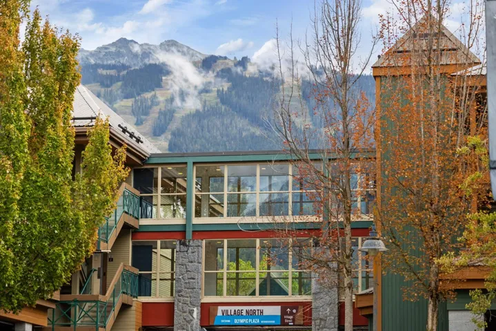 Rear view of house featuring a mountain view, stairs, and a balcony