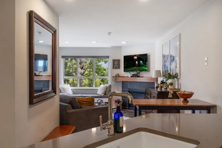 Living room with a tile fireplace and recessed lighting