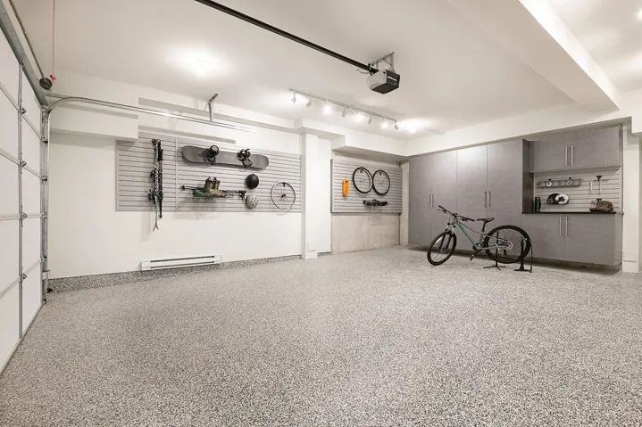 Garage featuring a baseboard heating unit and a garage door opener