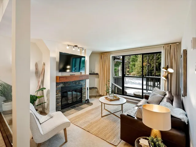Living room featuring rail lighting and a fireplace