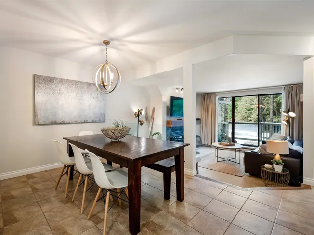 Dining space featuring baseboards, an inviting chandelier, and tile patterned floors