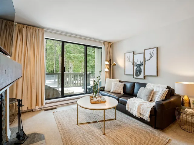 Living area featuring carpet flooring and visible vents