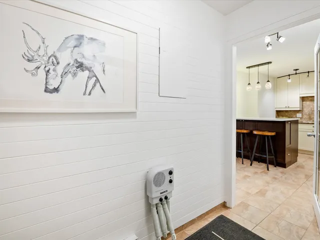 Bathroom with decorative backsplash, tile patterned flooring, and vanity