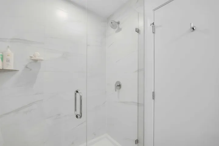 Bathroom featuring a marble finish shower