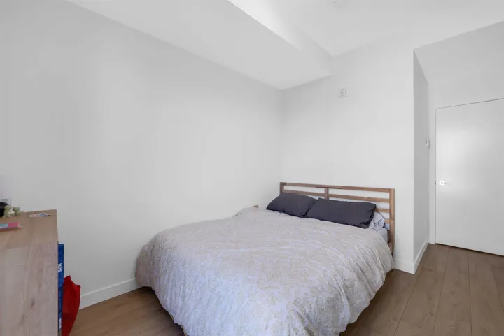 Bedroom with wood finished floors and baseboards