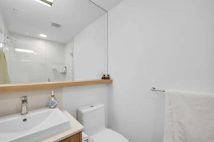 Full bath featuring a shower stall and vanity
