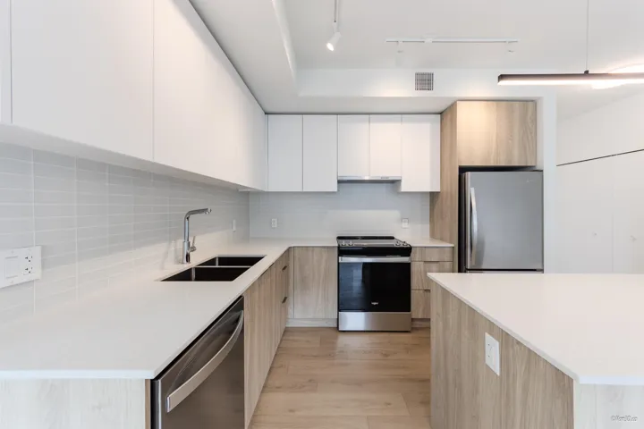 Kitchen featuring appliances with stainless steel finishes, modern cabinets, and light wood-type flooring