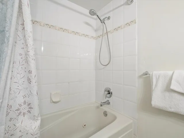 Full bath with shower / bath combination with curtain