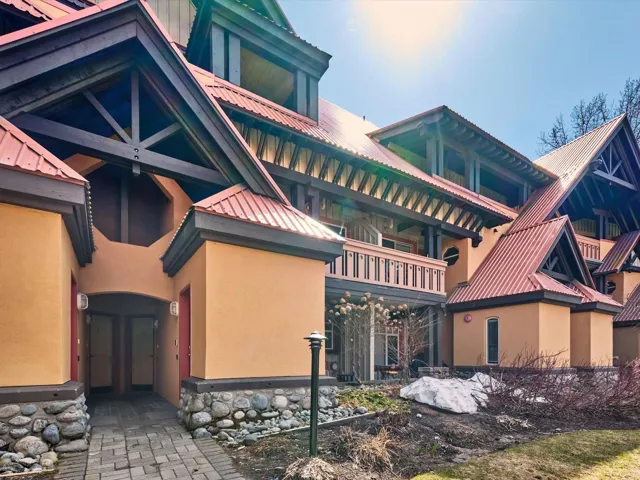 View of property exterior with stucco siding and metal roof