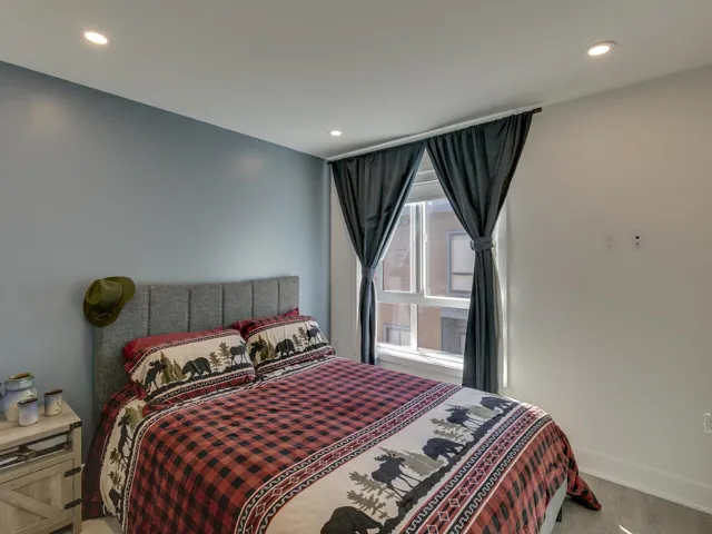 Bedroom featuring baseboards, light wood-type flooring, and recessed lighting