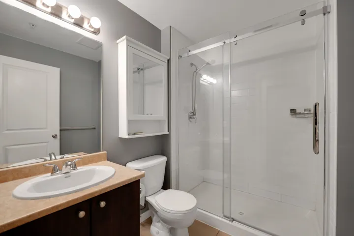 Full bathroom with vanity and a stall shower