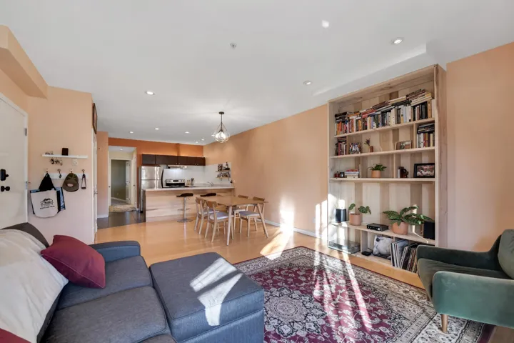 Living room with light wood-style flooring, recessed lighting, and a chandelier