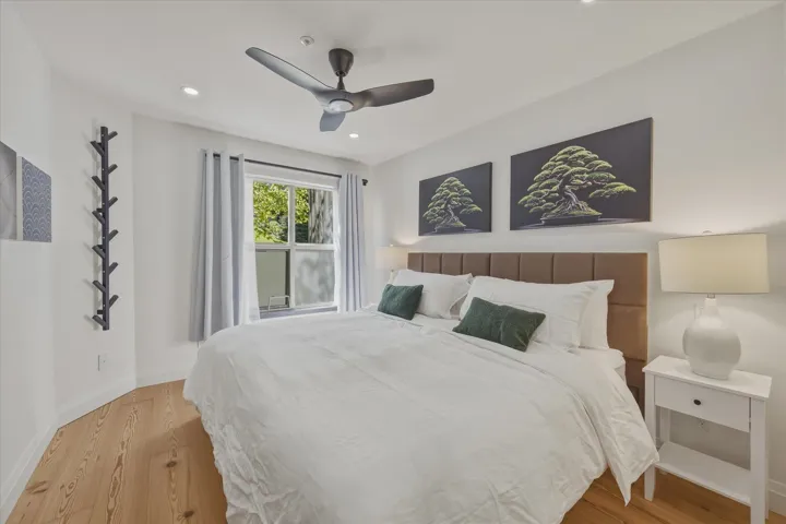 Recessed lighting, wood-finish flooring, and a ceiling fan
