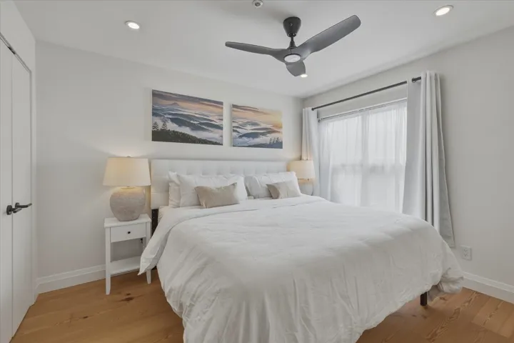 Hardwood-finish flooring, recessed lighting, and a modern ceiling fan with integrated lighting