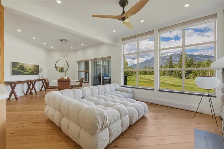 Expansive living space featuring wood-finish flooring, recessed lighting, and a ceiling fan