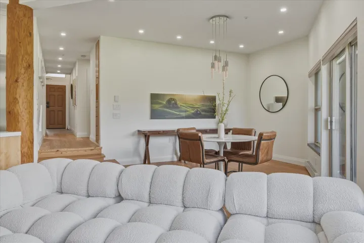 Recessed lighting illuminates wood-finish flooring