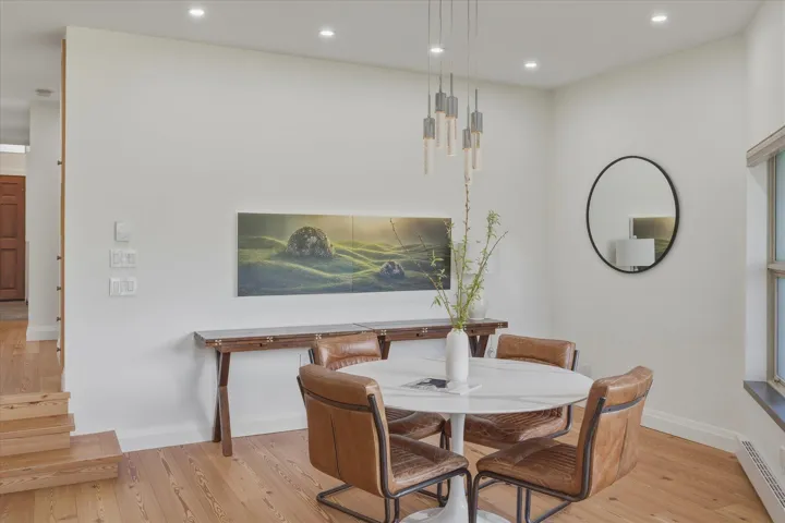 Wood-finish flooring, recessed ceiling lighting, and a modern chandelier