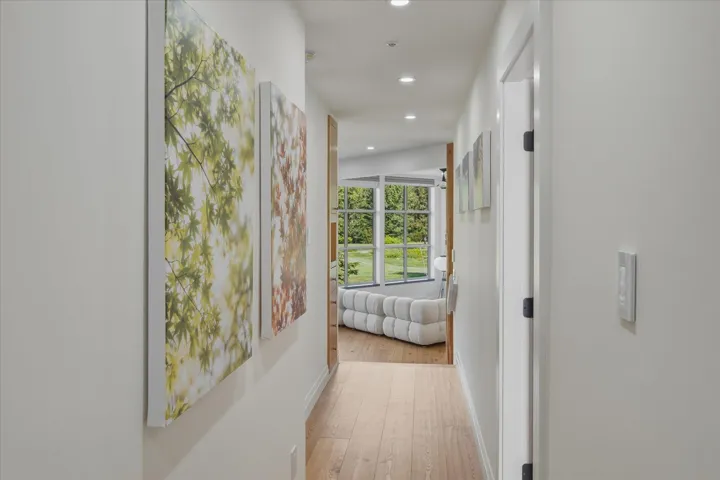 Recessed lighting illuminates the wood-finish flooring