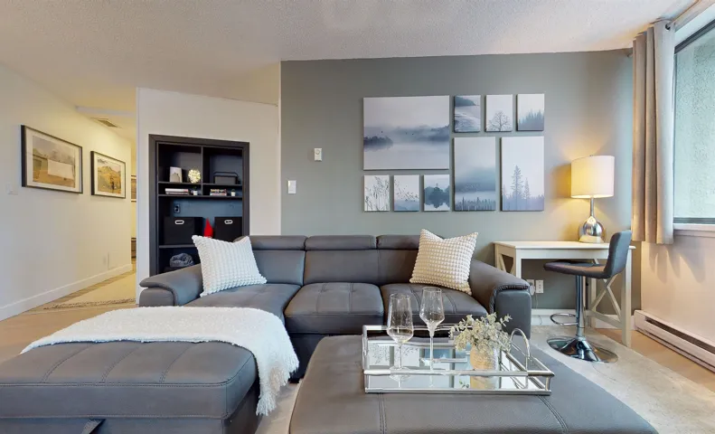 Living area with a textured ceiling and wood finished floors