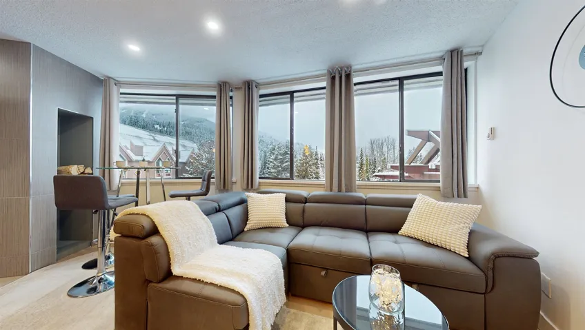 Living area featuring a textured ceiling and recessed lighting